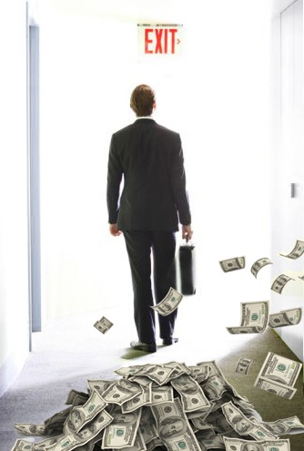 Businessman walking away from money